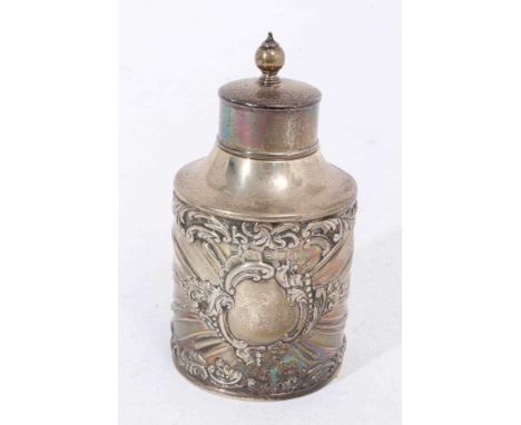 Late Victorian silver tea caddy of cylindrical form, with embossed foliate decoration and scroll surround cartouche, slip on 