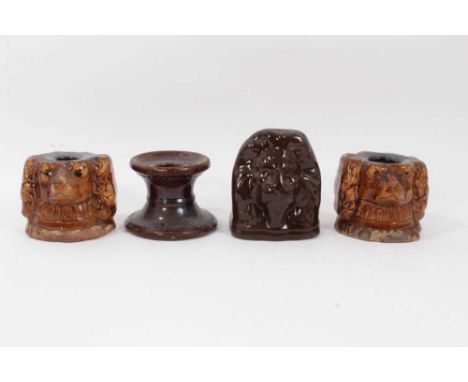 Four 19th century treacle glazed stoneware sash window stops, including a pair of spaniel form, one lion and another
