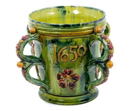 Castle Hedingham four handled pottery tyg, mottled green glaze, relief moulded with various motifs, the date '1650' and 'GR',