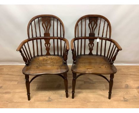 Pair of George III style fruitwood and elm windsor chairs, each with stick arched back and solid saddle seat on turned legs a