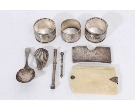 Victorian silver shell shape vesta case, George III silver caddy spoon, silver card case, three silver napkin rings, two silv