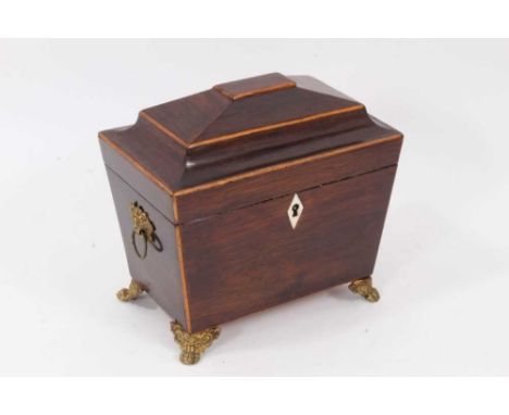 Early 19th century mahogany and boxwood line inlaid tea caddy, of tall sarcophagus form flanked by brass drop handles on orna