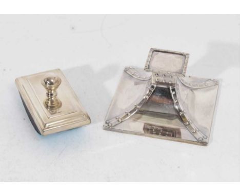 Edwardian silver inkwell of square tapering form, with strap decoration and hinged opening cover, glass reservoir missing (Sh