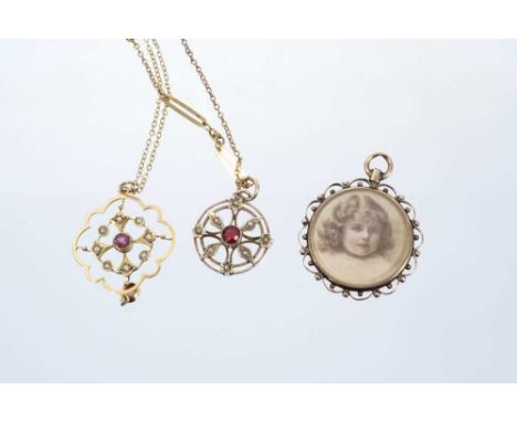 Two Edwardian gold garnet and seed pearl pendants on chains, together with an Edwardian double-sided portrait locket.