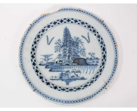 18th century English delftware charger, painted in underglaze blue with an island pattern, 34.5cm diameter