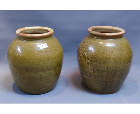 Two Malaysian green glazed ceramic baluster vases, H. 30cm