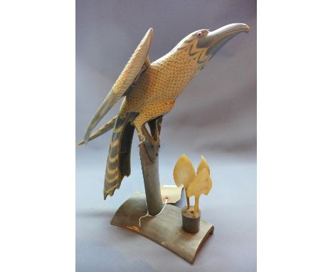 A 20th Century carved horn model of a bird of prey raised on horn stand, H:32cm