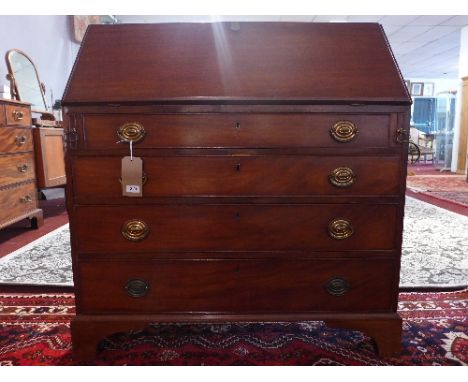 A Georgian mahogany bureau with drop flap enclosing fully fitted interior, having satinwood doors and drawers with marquetry 