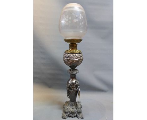 A Victorian silver plated oil lamp with ornate floral decoration having acid etched glass shade, H:92cm