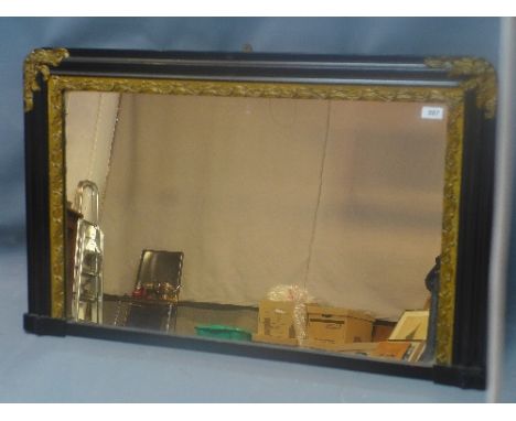An early 20th Century ebonised overmantle mirror with parcel gilding. 64x100cm 