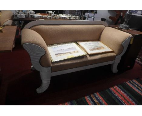 En early 20th Century Regency style two seater sofa with canvas upholstery raised on scroll legs