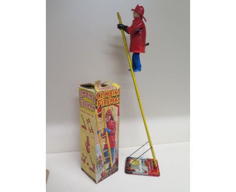 A tinplate and plastic Louis Marx &amp; Co clockwork climbing fireman with box - in working order 