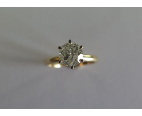 A yellow gold and white metal diamond solitaire ring with a round brilliant cut diamond approx weight 1ct - ring size L - app