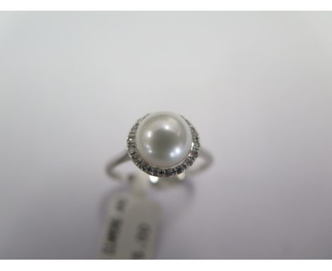 A 9ct white gold diamond and pearl ring size N - approx weight 2.2 grams - ex jewellers stock - as new condition - RRP £325 