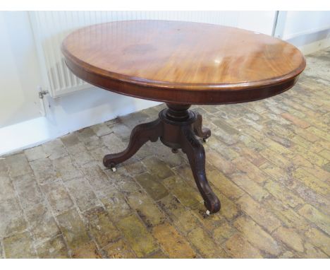 A Victorian mahogany circular tilt top breakfast table on a tripod base - Height 71cm x Diameter 101cm 