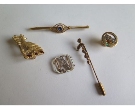 A 9ct yellow gold brooch with blue stone, a 9ct BMI pin, a broken gold enamel buckle part, a gilt metal serpent pin and a pla