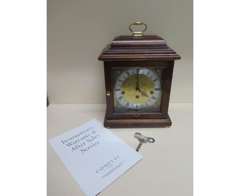 A Comitti of London mahogany mantle clock with Hermle chiming movement in good working order - Height 29cm 
