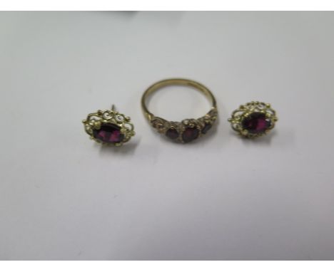 A 9ct hallmarked yellow gold ring size N with a pair of near matching earrings possibly garnets - total weight approx 3.7 gra