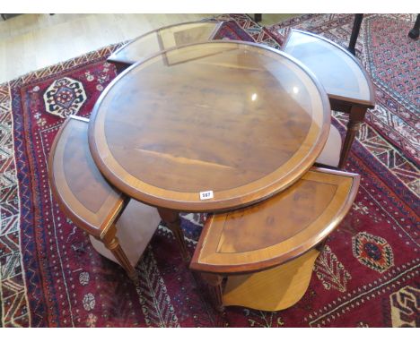A reproduction 20th century set of five yew wood tables, ebony strung and crossbanded comprising a circular coffee table with