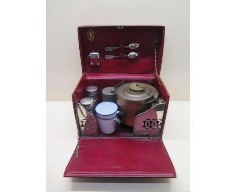 A tan leather en route/motoring/travel/tea/picnic case with a kettle and a burner, milk and sugar bottles, spirit container, 