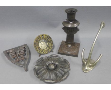 A collection of Arts &amp; Crafts iron items to include an Aesthetic candlestick, trivet, rosette and coat hook together with