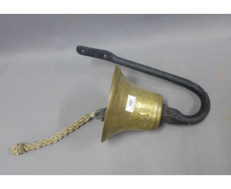 Brass bell with an iron wall bracket, inscribed MFV 1016