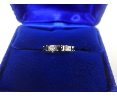 Five stone diamond and sapphire dress ring, the stones claw set to a white metal band, UK ring size K