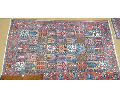 An old Persian Baktiari carpet, the all-over tile design on red/blue ground, 294 cm x 202 cm