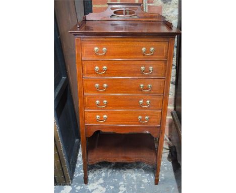 An Edwardian satinwood crossbanded walnut music cabinet with five hinged front drawers over an undertier