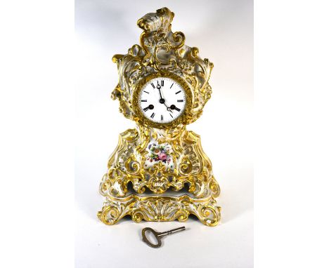 A French Jacob Petit porcelain clock, gilded rococo style case decorated with polychrome flowers, 30 cm high c/w matching sta