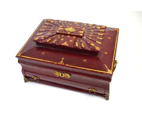 An early 19th century gilt-tooled red Morocco work-box of sarcophagus form with gilt mounts, top lidded trinket box above fit