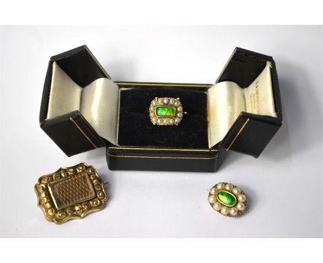 A Victorian mourning ring with seed pearl and green enamel face, inscription to verso dated 1870, yellow gold set stamped 9ct
