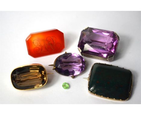 Three rectangular brooches, one yellow metal set smokey quartz, one yellow metal set bloodstone, one white metal set amethyst