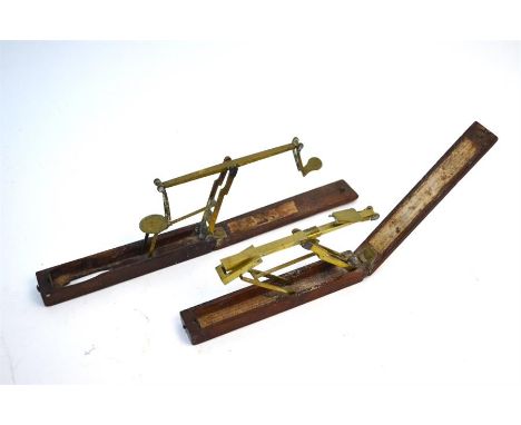 Two sets of 18th/19th century brass guinea scales, both bearing remnants of trade labels for A Wilkinson (2)