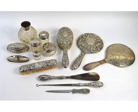 A quantity of silver-mounted dressing table items, including toilet jars, tortoiseshell-mounted globular scent bottle, brushe