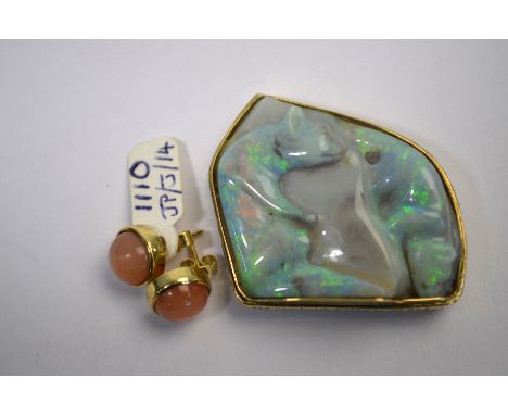 A pale green potch opal carved with two bears, set within an 18ct yellow gold textured and shaped mount with double brooch fi