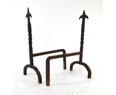 A pair of old wrought iron fleur-de-lys finial top spiral form fire dogs (2)