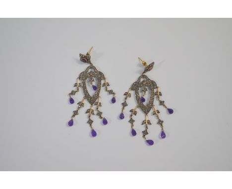 A pair of antique long drop chandelier earrings, the diamond and amethyst set quatrefoil with long diamond set centre and ame