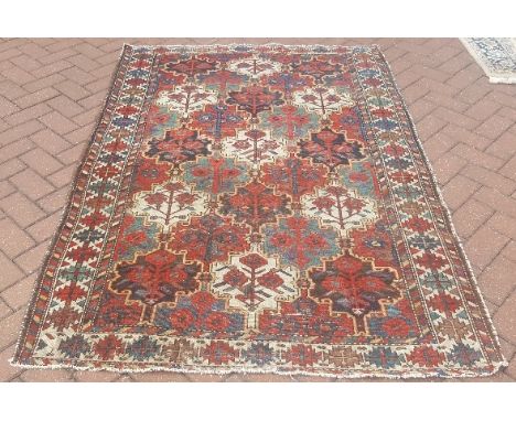 A Persian Bakhtiari rug, red ground tile design within guarded geometric border, 196 x 135 cm