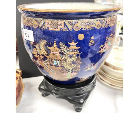 A Carltonware Kang-Hsi jardiniere with blue ground, on black base, height 20cm 
