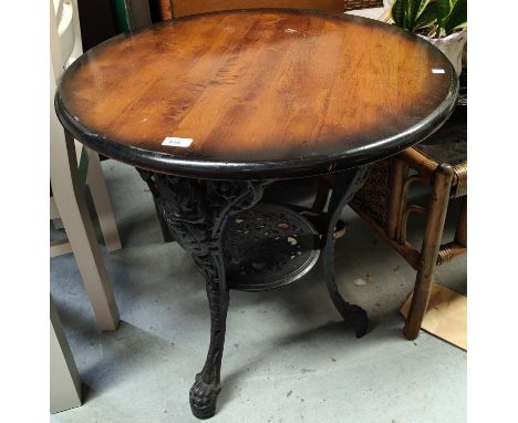 A 19th century cast iron based 'Britannia' circular pub table, with shelf bellow, diameter 69cm 