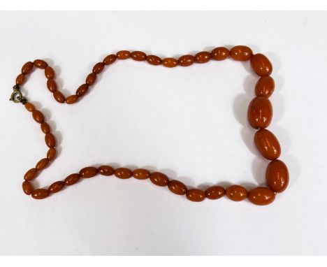 A vintage Amber coloured Bakelite necklace, graduating beads, internal swirl, largest bead 2.5cm, weight 51gms. 