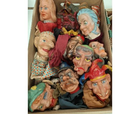 A selection of vintage one wooden headed and various plastic Punch and Judy hand puppetw