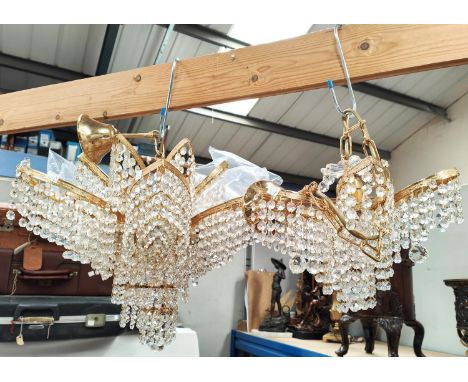 Two Swarovski ceiling light fittings brass with cut glass drops of lobed and tiered form.Appears in good condition. Layer cha