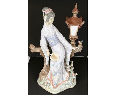 A large Lladro figure, Mariko Japanese Geisha Lamplight figure No. 01001421' a girl in a Geisha dress with a fan leaning agai