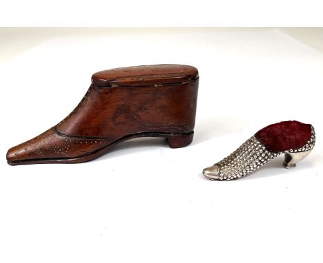 A 19th century novelty snuff box in the form of a boot; a novelty silver pin cushion in the form of a high heel shoe. 
