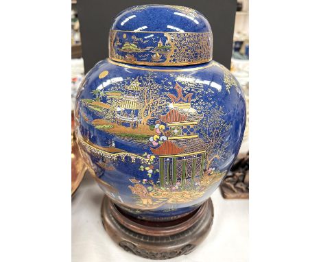 A Carltonware large ginger jar decorated with a chinoiserie river scene on blue ground, height 26cm, on carved hardwood base 