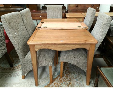 A light oak extending dining table, rectangular form with 6 modern dining chairs in fawn upholstery length 139cm&nbsp; with e
