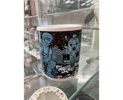 A commemorative mug issued to mark 'The First Landing on the Moon' with turquoise Pop Art decoration of astronauts, Made in E