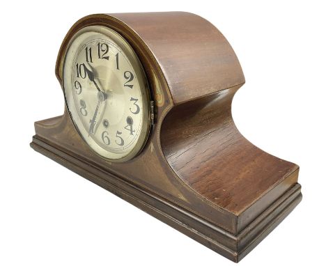 An early 20th century German mantle clock in a mahogany veneered Tambour case with mother of pearl inlay and satinwood bandin